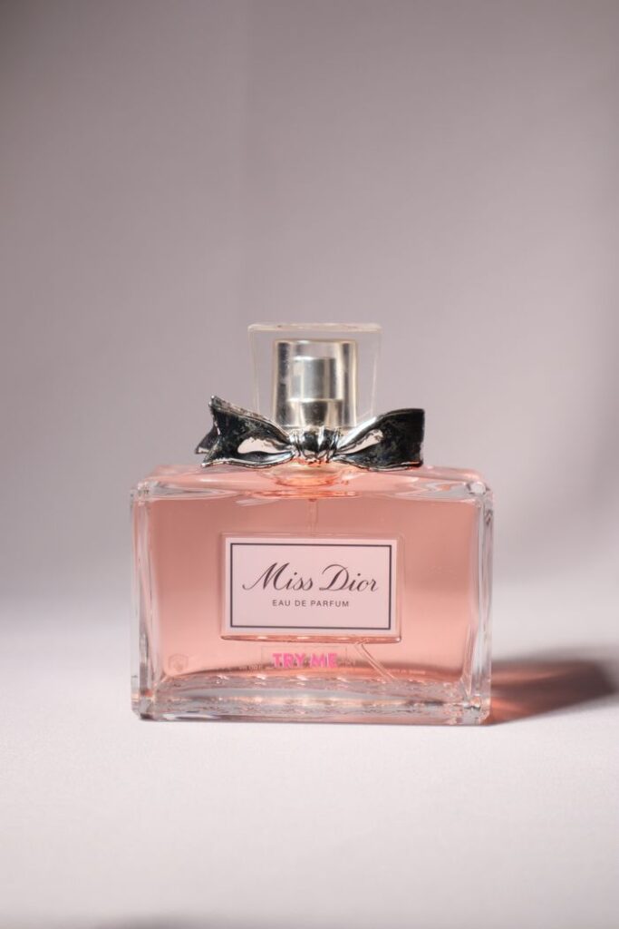 A sophisticated Miss Dior perfume bottle with a bow, captured in soft lighting.